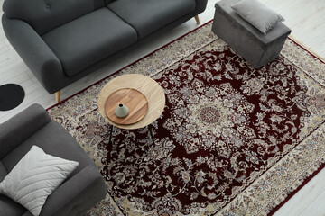 Wall Mural - Cozy room interior with stylish furniture and soft carpet with beautiful pattern, view from above