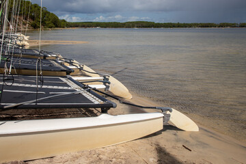 Wall Mural - Carcans Medoc water beach lake with boats on sand in summer day