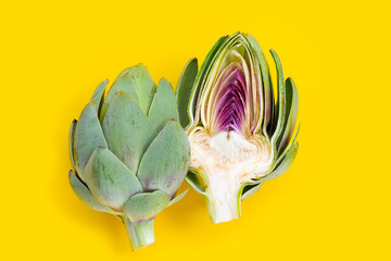 Fresh artichoke on yellow background