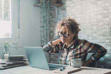 Wall Mural - Tired woman massaging rubbing stiff sore neck tensed muscles fatigued from computer work in incorrect posture feeling hurt joint shoulder back pain ache, fibromyalgia concept, home work place laptop