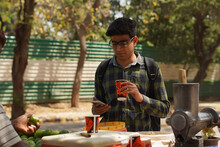 Young Indian Middle Class Young Man Drinking Juice From Roadside Vendor 