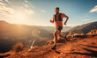 © Mangsaab - A trail runner running up a mountain trail as the sun rises behind him over the mountain peaks.