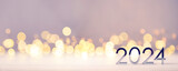 Fototapeta  - Metal numbers 2024 on a white table with Christmas trees and bokeh lights. Happy New Year 2024 is coming concept.