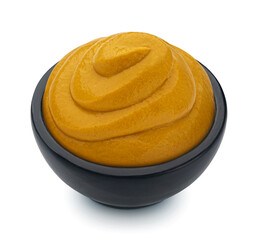 Wall Mural - Mustard in black bowl isolated on white background, full depth of field