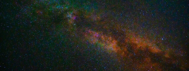 Wall Mural - starry night sky with stars, galaxies and a bright multicolored milky way. panorama, panoramic wide 