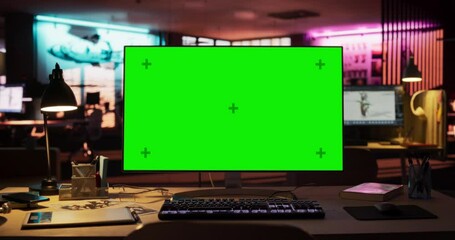 Leinwandbilder - Zoom In Shot of Desktop Computer Monitor Standing on a Wooden Desk with a Green Screen Chromakey Mock Up Display. Creative Office Working Station for Game Developer in Creative Agency