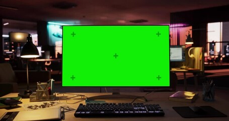 Leinwandbilder - Zoom Out Shot of Desktop Computer Monitor Standing on a Wooden Desk with a Green Screen Chromakey Mock Up Display. Creative Office Working Station for Game Developer in Creative Agency