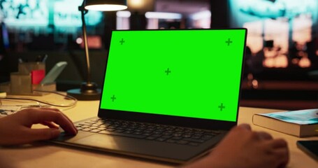 Leinwandbilder - Close Up on Anonymous Designer Working on a Laptop Computer with Mock Up Green Screen Chromakey Display with Isolated Placeholder. Video Template for Artistic Content Creation and Presentations