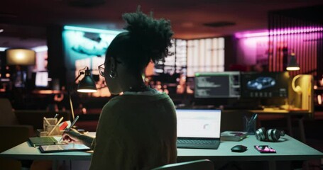 Aufkleber - Backview: Motivated Black Female Using Laptop and Tablet Computer in Creative Agency in the Evening, Manager Working on Implementing Business Strategy for Client. Specialist Writing Project Plans