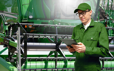 Fototapete - Farmer with digital tablet on a background of harvester. Smart farming concept