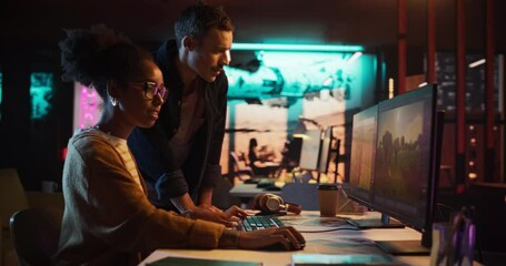 Fototapete - Portrait of Young Creative Director and Female Designer Talking About Work, Making Changes on Project. Two Stylish Diverse Employees Discussing Level Landscape on Computer in Game Development Company