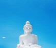 Big Buddha white marble statue by blue sky in Phuket, Thailand