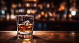 Fototapeta Dziecięca - Glass of whiskey with ice cubes on wooden bar counter