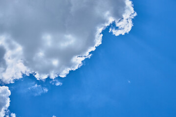 two white clouds in a blue sky