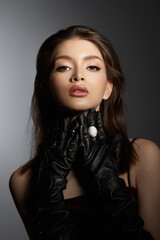 Wall Mural - Fashion Woman in black gloves, portrait. Long hair, beauty beautiful eyes