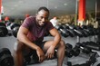 © Serhii - Tired african american man tired after working out in the gym.