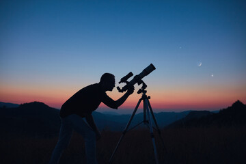 Wall Mural - astronomer looking at the starry skies and crescent moon with a telescope.