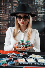 Pretty young  women posing at playing table in casino