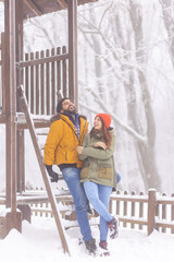 Wall Mural - Couple relaxing outdoors on snowy winter day