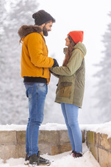 Wall Mural - Couple relaxing outdoors while on winter vacation