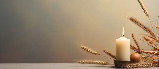 Poster - Candle dry autumn leaves with wheat isolated pastel background Copy space