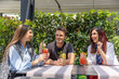 © rilueda - Friends drinking cocktails in garden restaurant