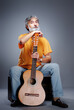© luengo_ua - Aged bearded man with an acoustic guitar