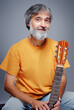 © luengo_ua - Aged bearded man with an acoustic guitar