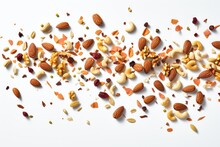 A Close-up Shot Of Various Mixed Nuts Scattered On A White Surface