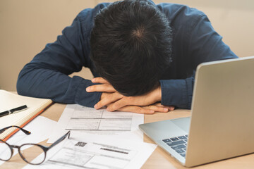 Entrepreneur exhausted, Stress asian young business man working with headache, suffer on hard work while work on laptop computer at office. Overtime job, debt problem and despair people. Sick unwell.