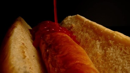 Wall Mural - Close-up of a sandwich with jam on a black background.