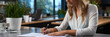 © Sudarshana - A cute office staff lady wearing white top thinking and signing a letter with pen in right hand on a white color paper
