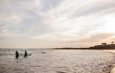 Wall Mural - Two Young People Man And Woman Surfing Together On Ocean Beach