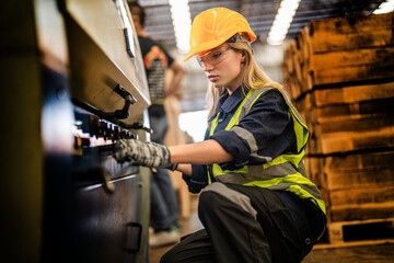 Factory engineer woman standing confidence to control panel switch. Worker works at heavy machine at industry factory. with machinery equipment plant technology. smart industry worker operating.