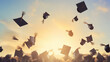 © Studio Nova - College graduated students throwing their caps up in celebration of graduation