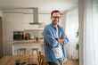 © Miljan Živković - One adult man with eyeglasses stand at home happy smile