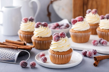 Wall Mural - Spiced cinnamon and cranberry cupcakes topped with sugared cranberries for Christmas or Thanksgiving