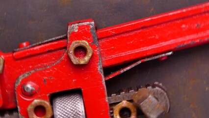 Wall Mural - old rusty wrench and bolts rotating. Old rusty repair tools on black background. Workshop or repair concept