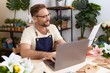 © Krakenimages.com - Middle age man florist using laptop reading document at flower shop