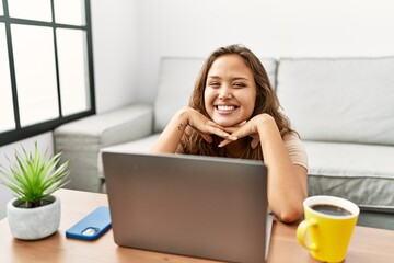 Wall Mural - Young beautiful hispanic woman using laptop sitting on floor at home