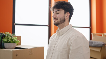 Poster - Young hispanic man breathing with closed eyes at new home