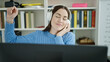 © Krakenimages.com - Young caucasian woman student listening to music and dancing at library university