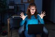 © Krakenimages.com - Brunette woman working at the office at night celebrating mad and crazy for success with arms raised and closed eyes screaming excited. winner concept