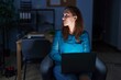 © Krakenimages.com - Brunette woman working at the office at night looking to side, relax profile pose with natural face with confident smile.