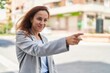 © Krakenimages.com - Young woman executive pointing with finger at street