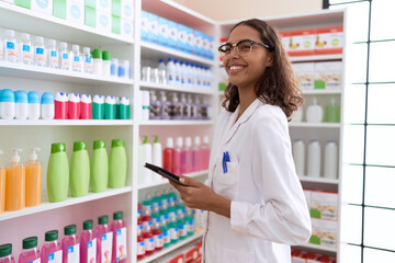 Sticker - Young african american woman pharmacist using touchpad working at pharmacy