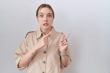 Sticker - Young caucasian woman wearing casual shirt pointing aside worried and nervous with both hands, concerned and surprised expression