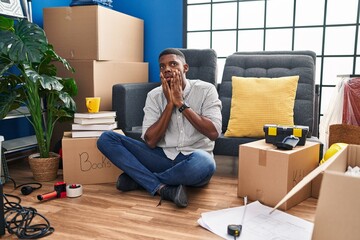 Sticker - African american man sitting on the floor at new home tired hands covering face, depression and sadness, upset and irritated for problem