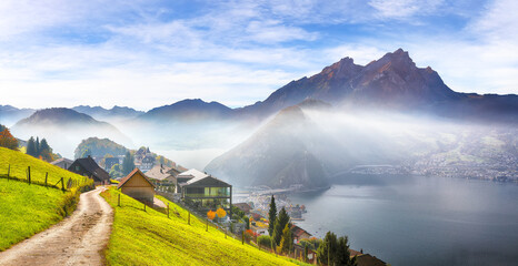 Wall Mural - Gorgeous autumn view on suburb of Stansstad city and Lucerne lake with mountaines and fog