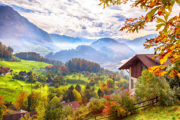 Wall Mural - exciting autumn view on suburb of stansstad city and lucerne lake with mountaines and fog